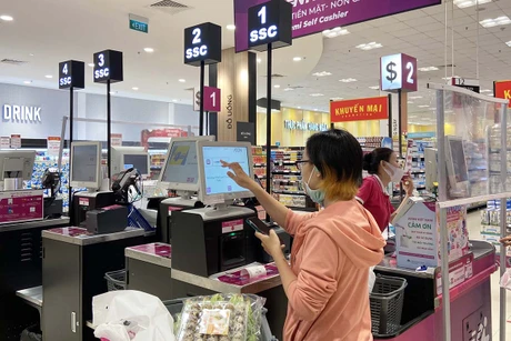 A person in a pink hoodie using a computer Description automatically generated