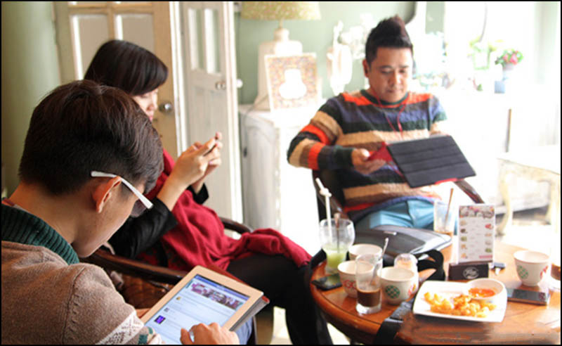 A group of people sitting around a table Description automatically generated