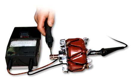 A hand holding a tool to a machine Description automatically generated