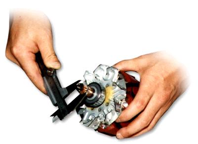 Close-up of a person's hands holding a tool Description automatically generated